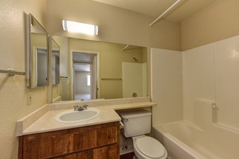 Bathroom with Toilet, Shower, Hardwood Inspired Floors and Sink